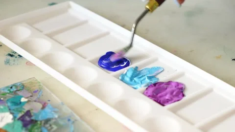 Artistic Process of Mixing blue and pink Pigments on a Palette. Stock Footage 247715282