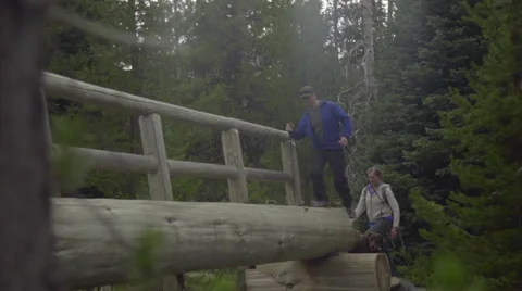 Artistic shot of hikers crossing a bridge Stock Footage 59132004