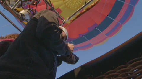 Artistic shot of man in hot air balloon Stock Footage 59806102