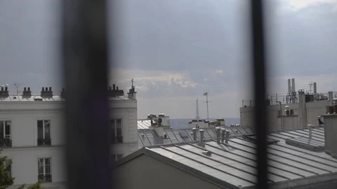 An artistic shot of a view over typical rooftops in Paris with the Eiffel Stock Footage 98990722