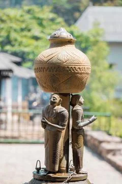 Artistic stone pond with statues of three people Stock Photos