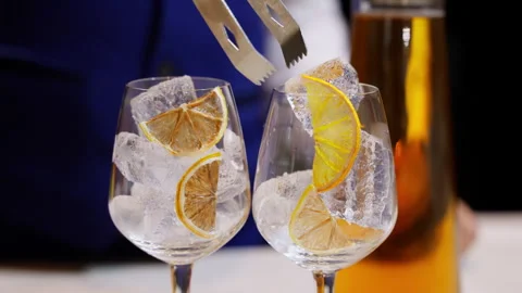 An artistic touch as a dried orange slice gently rests on a bed of ice within a Video stock 249886701