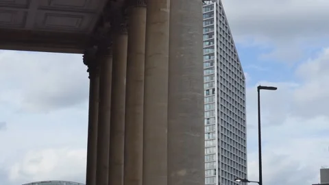 Artistic video shot of a skyscraper behind tall columns. Stock Footage 289880655