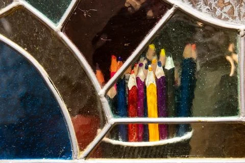 Artistic View of Colored Pencils Through Multi-Colored Stained Glass Window Stock Photos