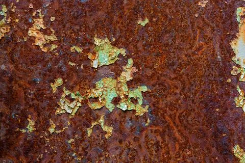 Artisticly rusted flat iron surface with leftowers of peeled off paint Stock Photos