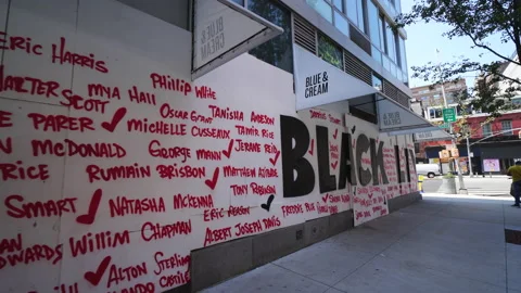 Artists create murals on the barricade board of stores windows in East Village. Stockbeeldmateriaal 134494579