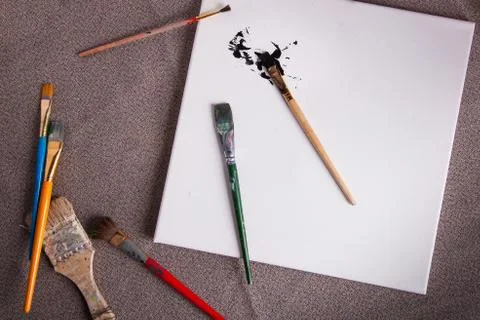 Artists creative worksoace paint brushes black paint splatter Stock Photos