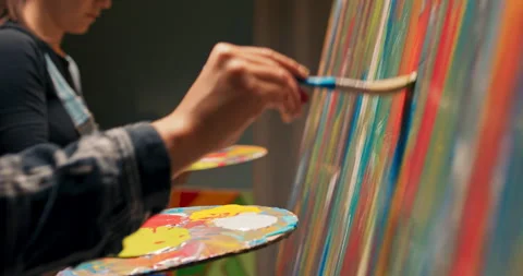 Artist's dressed in work's clothes developing passion together, painting an Stock-Footage 160374753