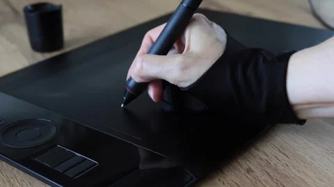 Artist's hand draw with a digital pen on a black graphics tablet Stock Footage 340141843