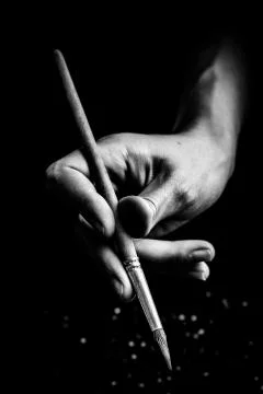 The artist's hands hold a brush Фото