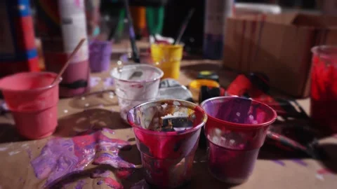 Artist's studio. Paint-stained cups Stock Footage 229687483