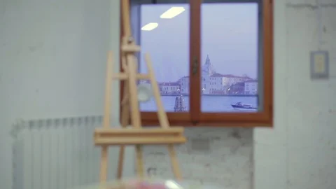 Artist's studio in Venice - handheld shot of an easel by window with a view of 스톡 동영상 128317283