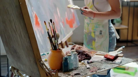 The artist's tools are brushes, paints, palette, canvas, easel, oil painting in Stock Footage 236747556