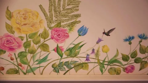 The artist's work painted with a brush flowers, on the ceiling in the room Stock Footage 224510498