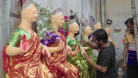 Artists working on the Goddess Durga statues in workshop before the festival Stock Footage 274699000