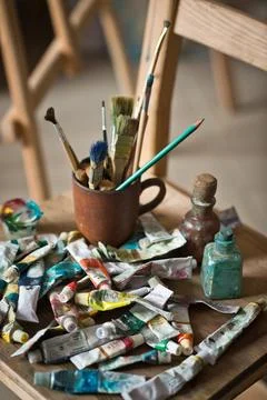 The artists workplace with a bunch of brushes and tubes of paint 2881. Stock Photos