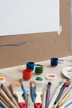 Artist's workplace. Everything is ready for work. Brushes, paints, palette Stock Photos