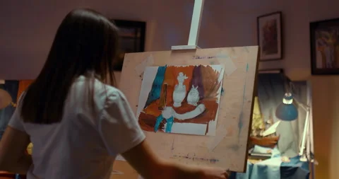 Artist's workplace, objects are on the table, still life. Woman paints a picture Stock Footage 167977214