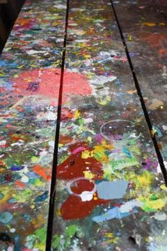 Artists workshop or studio bench covered with splattered paint built up in au Stock Photos