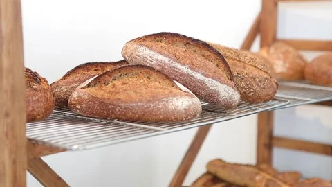 Artsinal bread lying on a shelf in a bakery shop Stock Footage 167654028