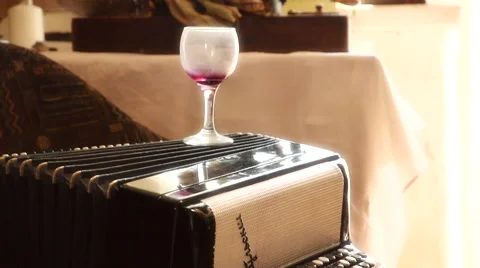 Artstudio: jars of paints in an old box, accordion, a glass of wine, woman legs. Stock Footage 65780046