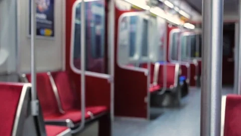 Artsy focus roll from the safety bar to red seats on an empty subway car Stock Footage 82372112