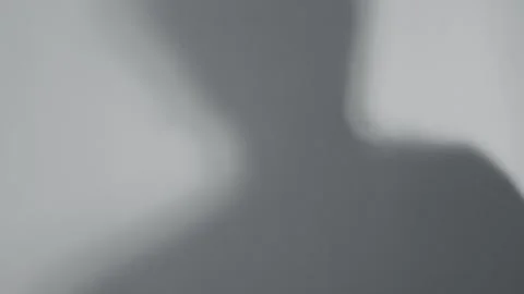 This artwork showcases a silhouette shadow cast on a wall, creating an abstract Stock Footage 321374749