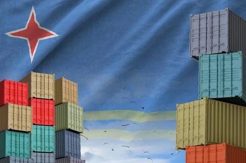 Aruba flag and big stack of shipping cargo containers in docks with sky Foto stock