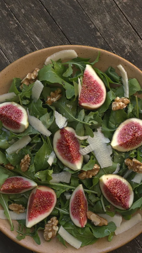 Arugula and fig salad. Vertical video. Stock Footage 308746717