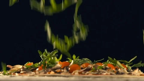 Arugula falls on pizza. Slow Motion Stock Footage 74493777