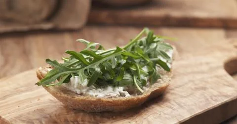 Arugula on rustic bread with ricotta cheese Stock Photos
