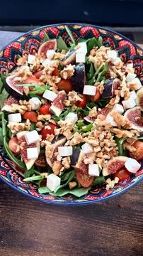 Arugula Salad with Figs, Walnuts and Feta in Decorative Bowl Stock Photos