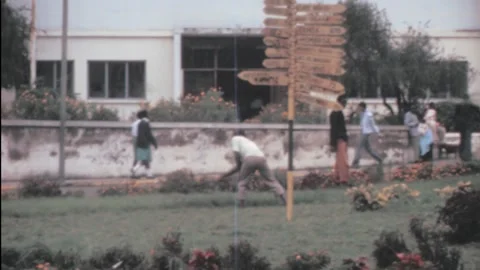 Arusha, Tanzania - 1983: men work in a roundabout as gardener Stock Footage 159643284