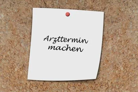 Arzttermin machen written on a memo Stock Photos
