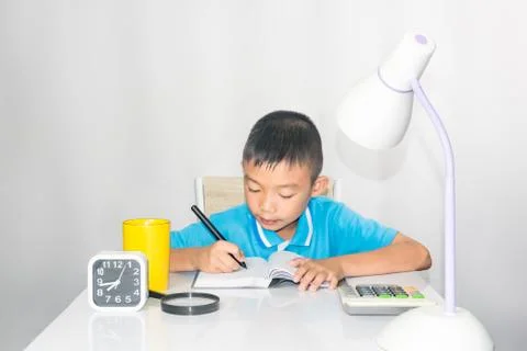 Asain kids working and learning on table on white background Stock Photos