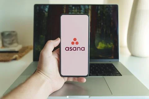 Asana project management application logo on smartphone screen in front of Stock Photos