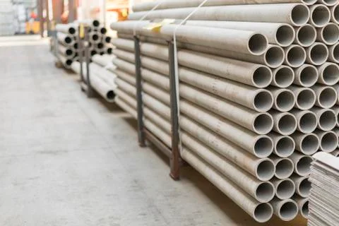 Asbestos pipes in a stack in a warehouse or in a building store Stock Photos