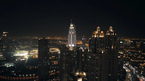 Ascending from 100m to 200m while paning left to reveal Burj Khalifa, night. Stock Footage 98973433
