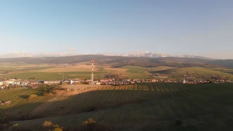 Ascending aerial view above patchwork, agricultural farming countryside to Stock Footage 107749254