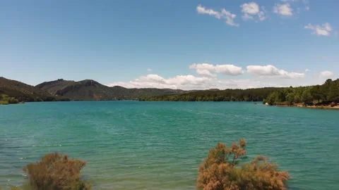 Ascending Aerial View of a Lake with Mountains in the Background Stock Footage