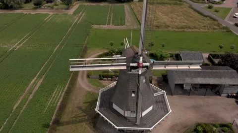 Ascending aerial view of typical Dutch windmill with wicks in rural Stock Footage 157464376