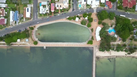 Ascending Ariel View Of Wynnum Wading Pool, Jetty, beach &amp; Surrounding Parks Stock Footage 263953257