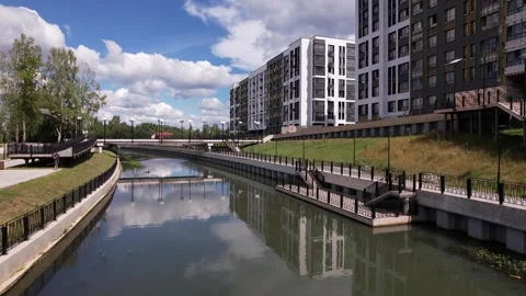 Ascending drone flight over river and Rafinad housing complex Stock Footage 329743154