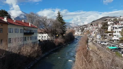 Ascending Drone Over Alpine River Toward Bressanone Town with Cathedral 库存影片 335838416
