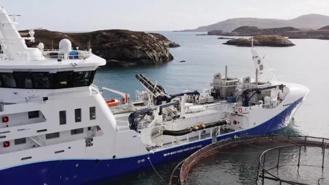 Ascending drone shot of the deck on a fish farming vessel by a fish cage. Video stock 249816801