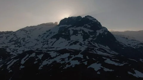 Ascending Drone Shot Facing a Mountain as Sun Peeks Over In Lofoten Stock Footage 116411862