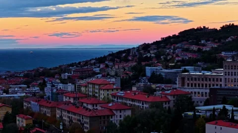 Ascending drone shot over Trieste at sunset, revealing hillside neighborhoods Stock Footage 324771632