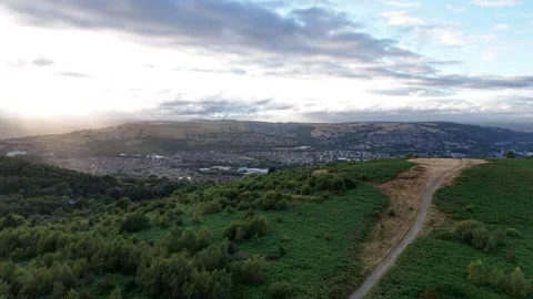 Ascending Drone View of Caerphilly Mountain with Sun Through Clouds Stock Footage 343577432