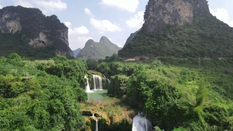 Ascending Drone View Revealing Emerald Waterfall Pools in Karst Forest Guangxi Stock Footage 330280029