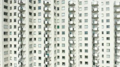 Ascending the exterior of a high rise multi story residential apartment building Stock Footage 130690997
